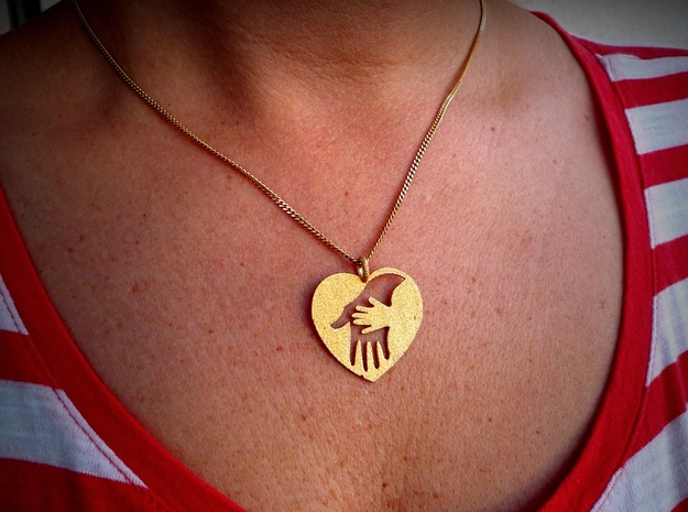 Mother/child holding hand pendant. in Polished Gold Steel
