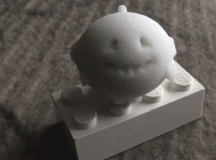 Bubbie's Little Guy 3d printed in sandstone, on a Lego brick to show scale
