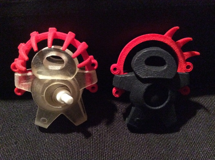 Ellyba Headdress Two (2) - Small 3d printed The Black Golem on the right, is holding a Red Headdress Two