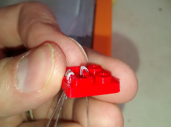 LEGO® Power Functions-compatible socket base 3d printed Each contact is then inserted through one of the holes and folded again to go through the opposite hole.