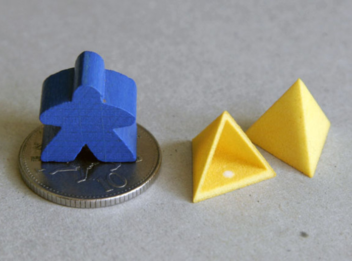 Tetrahedron Capstones (x15) 3d printed Showing scale with ten pence coin and meeple. Also shows the sprue cut-off point inside the capstone.