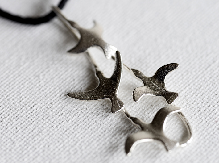 Flying Birds Pendant 3d printed pendant in raw silver on white background