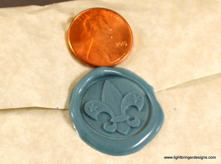 Fleur-de-lis Wax Seal 3d printed Fleur-de-lis impression in Light Blue sealing wax, with penny for scale.