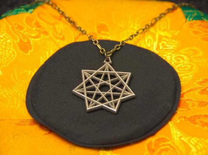 Double Heptagram Pendant 3d printed Photo of Stainless Steel pendant on a chain.