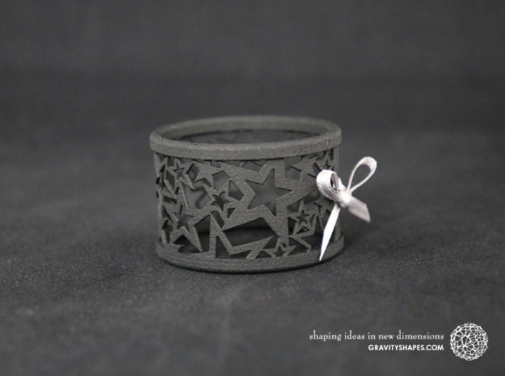A large Christmas napkin ring with Stars 3d printed The photo shows a print made of black strong and flexible incl. silver lacing.