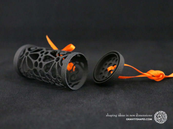 Filigree Gift roll small with Mosaic-3 (6 cm) 3d printed The photo shows a print made of black strong and flexible incl. orange lacing.