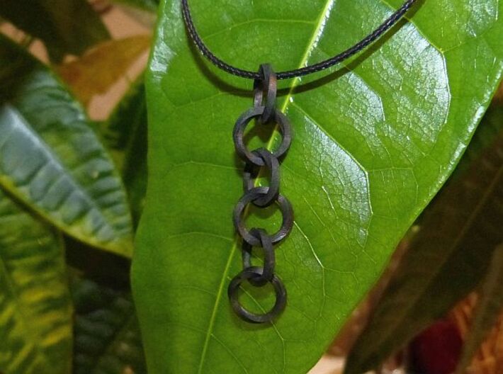 Twisted rings chain - Earrings or Pendant 3d printed Frosted Extrem details comes out white, but if you paint it in Black yourself it will provide a very fine level of detail.