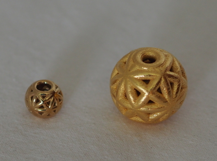torus_pearl_loop_type8_normal 3d printed Polished Brass is Small and Polished Gold Steel is Medium.