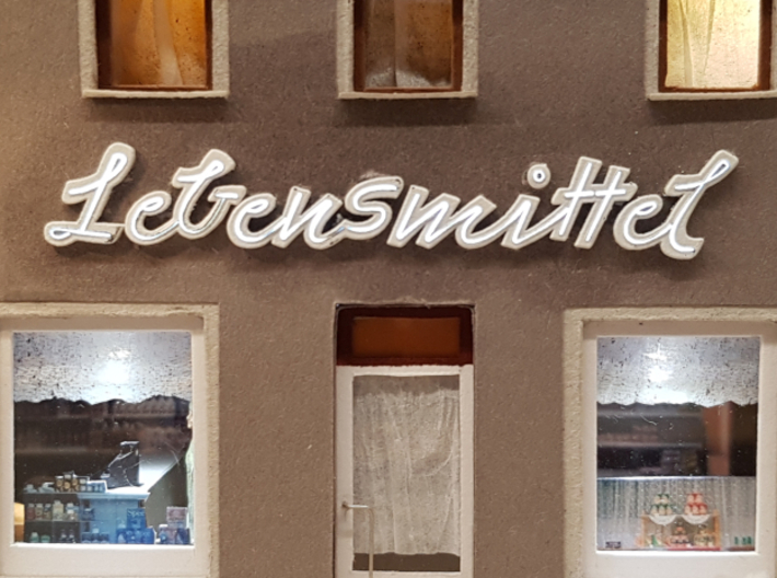 Lebensmittel-Leuchtschrift-N-flackernd 3d printed Die hinterleuchtete Schrift an einer Hausfassade