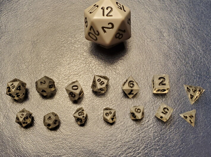 8x Tiny Polyhedral Dice Set, V4 (1.25x Scale) 3d printed A customer's 1.25x 'Tiny' dice between a regular d20 and the 1x scale 'Super Tiny'  dice.