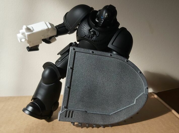 Action Figure Chainshield - Left Handed 3d printed Printed in Grey PA12, held by a 1:12 scale action figure, along with  an Action Figure Bolt Pistol