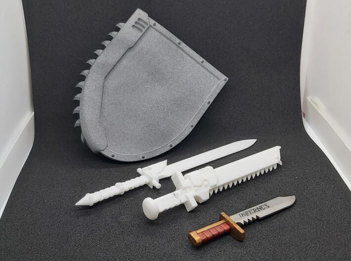 Action Figure Powersword 3d printed Printed in White Natural Versatile Plastic, shown with an Action Figure Chainshield, an Action Figure Chainsword and a combat knife from a 1:12 scale action figure