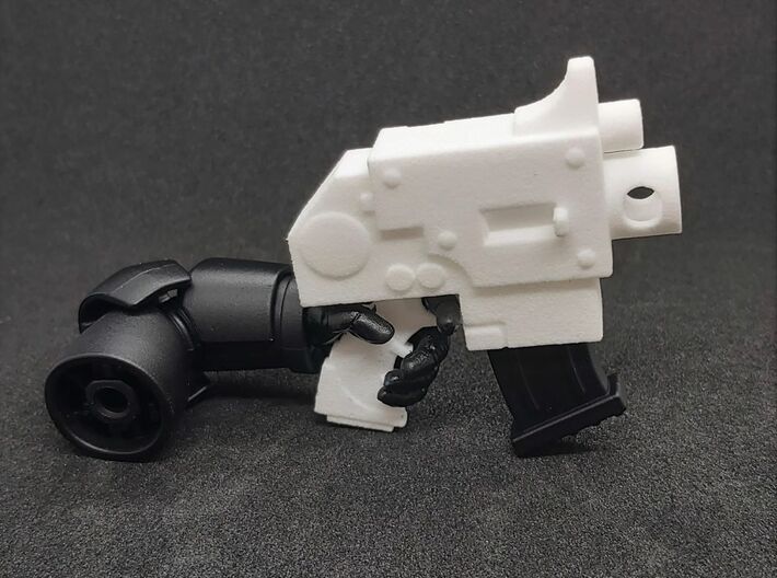 Action Figure Bolt Pistol 3d printed Printed in White Processed Versatile Plastic, shown with the arm and magazine from a  1:12th scale action figure