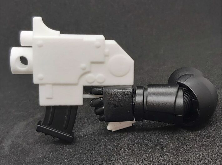 Action Figure Bolt Pistol 3d printed Printed in White Processed Versatile Plastic, shown with the arm and magazine from a  1:12th scale action figure