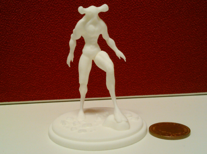 The Stalking Horror 3d printed White Strong &amp; Flexible front compared to a 2p coin.