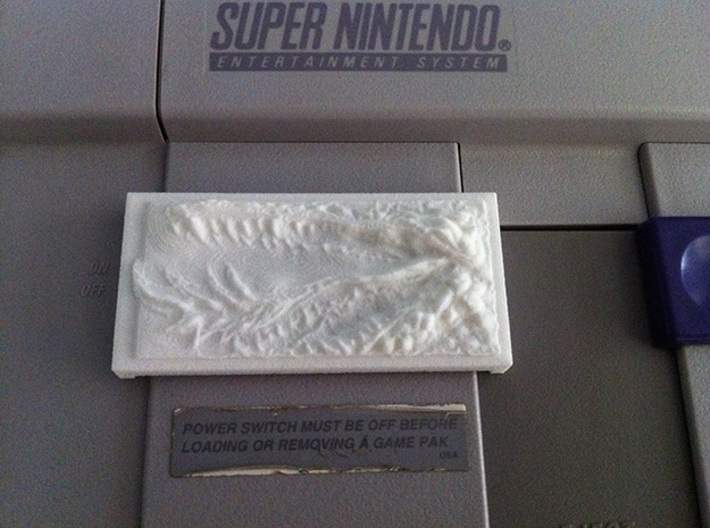 DragonMouth Plastic Power/Reset Button Cover 3d printed The cover in use on an SNES unit.
