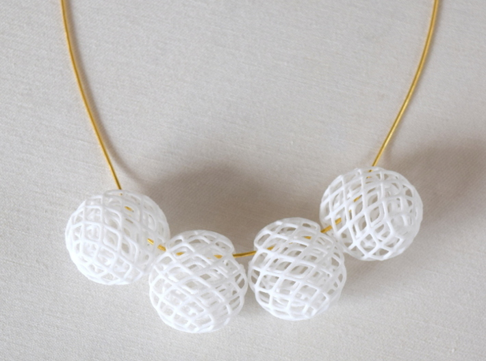 Bud Bead 3d printed in this image, the beads are chained up on a gold plated snake chain