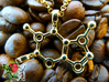 Caffeine 3d printed Detail of 18k gold-plated caffeine pendant on a heap of freshly roasted coffee beans.
