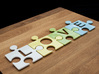 Puzzle Piece V - "Love-letters" 3d printed 4 puzzle pieces combined to write the word "love".