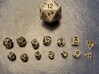 1x Tiny Polyhedral Dice Set, V4 (1.25x Scale) 3d printed A customer's 1.25x 'Tiny' dice between a regular d20 and the 1x scale 'Super Tiny'  dice.