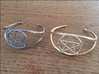 Woven Pentacle cuff/armband 3d printed The woven pentacle armband in two different materials. On the left is stainless steel; on the right is polished gold steel. 